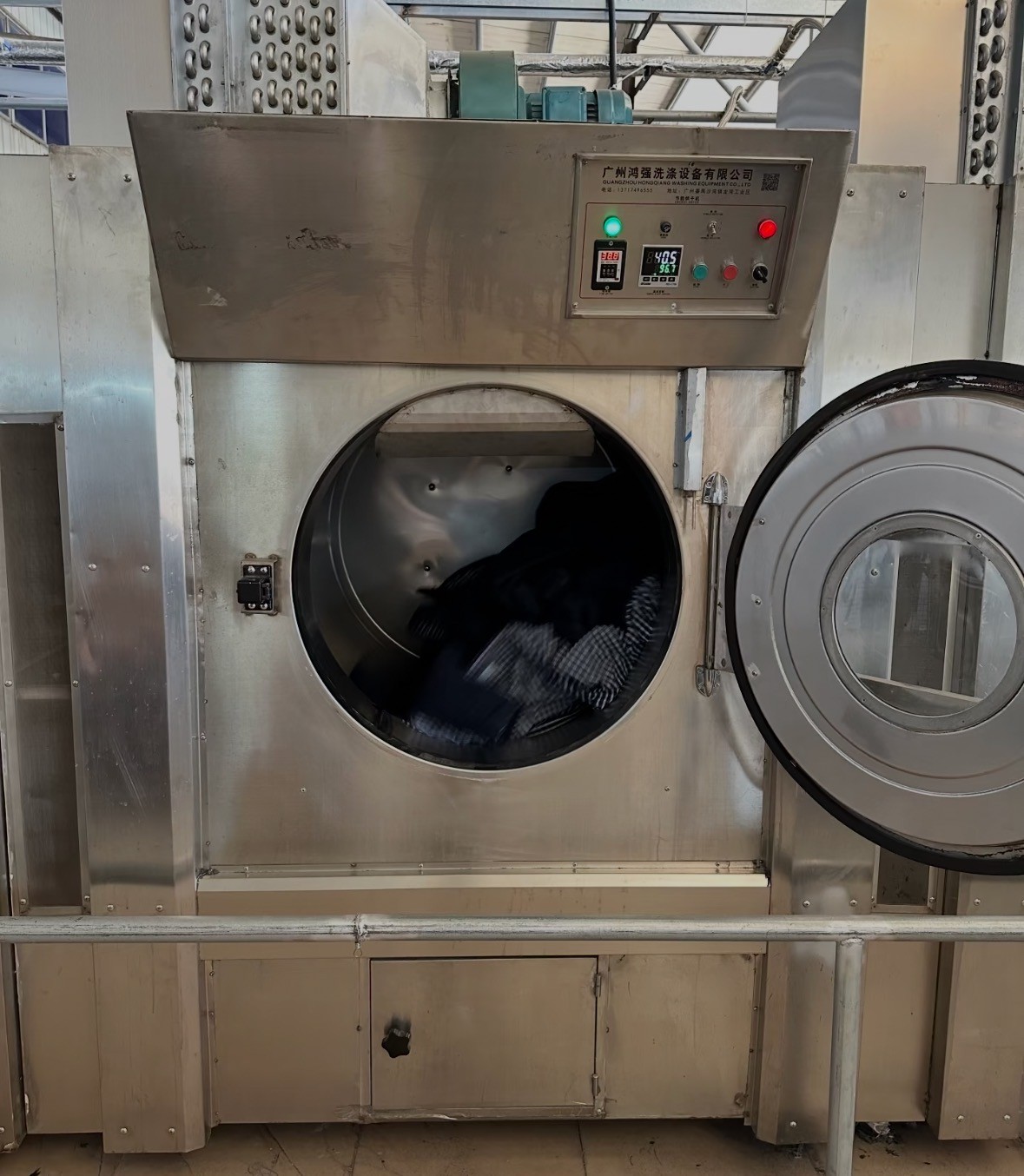 Industrial drum equipment processing denim garments